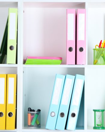 White office shelves with folders and different stationery, close up White office shelves with folders and different stationery, close up